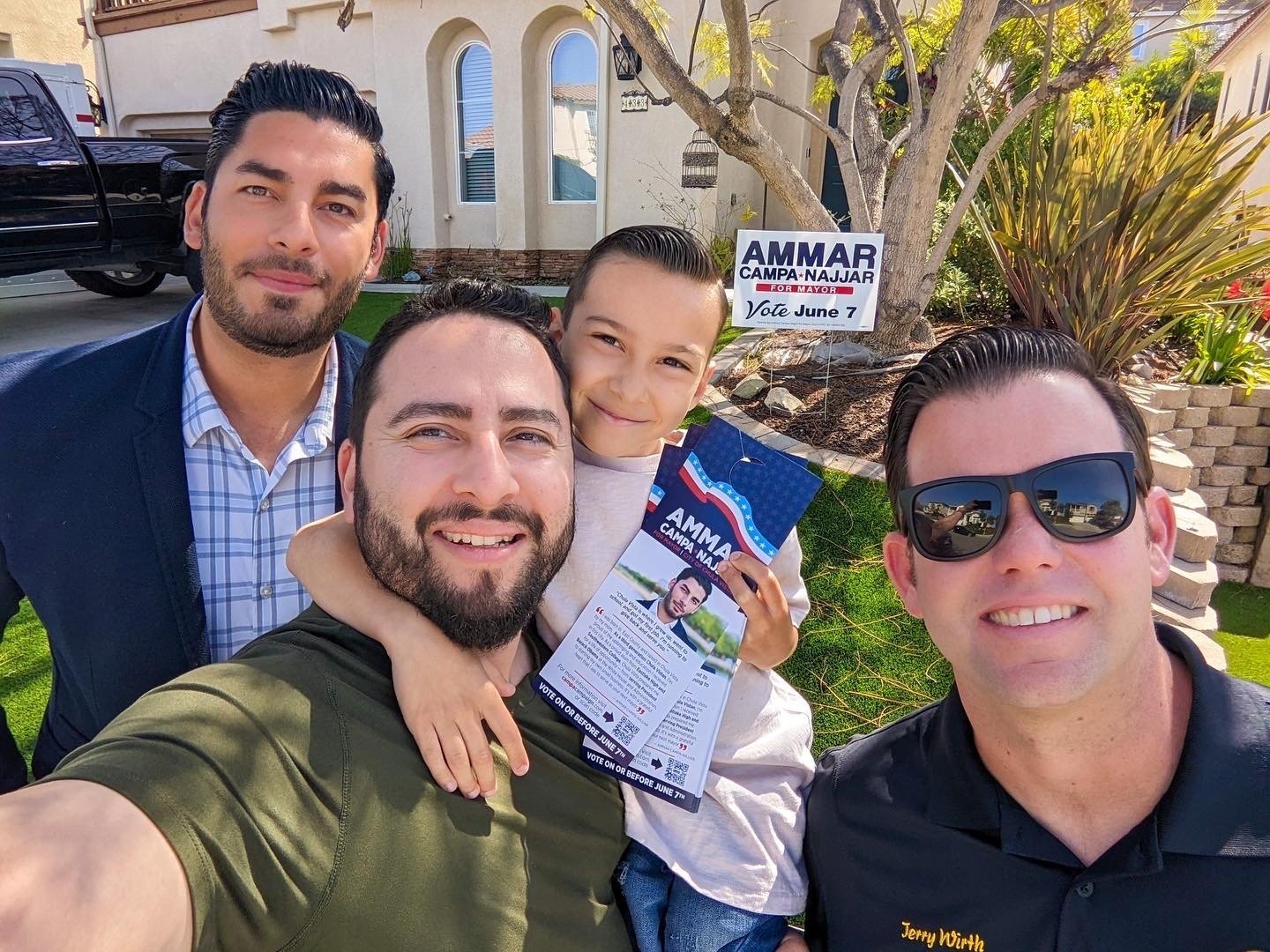 Ammar canvassing with his cousin Marty, godson, and volunteer.
